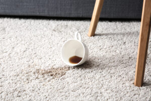 Cup of coffee spilled on carpet.